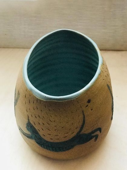 A slightly different angle of the "Midnight Mischief" bowl, highlighting the texture of the outer clay.