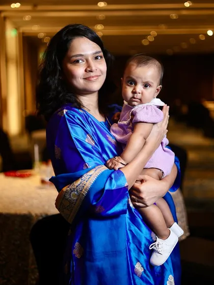 A mother and her baby posing for a portrait at a family function. I make sure to get photos of guests as well as the main hosts.