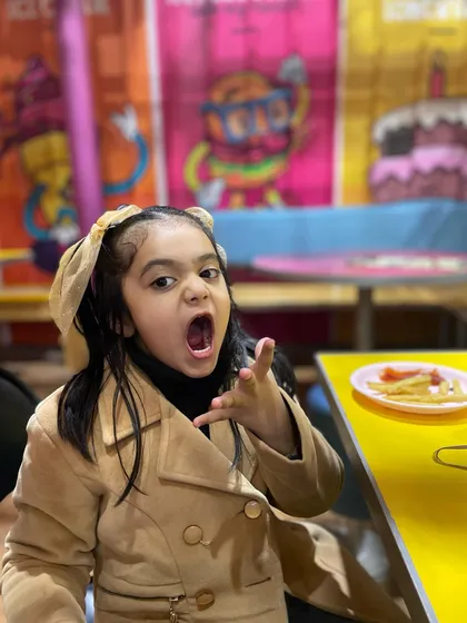 This little guest is showing some serious attitude about her delicious plate of fries. Our food is definitely worth protecting.