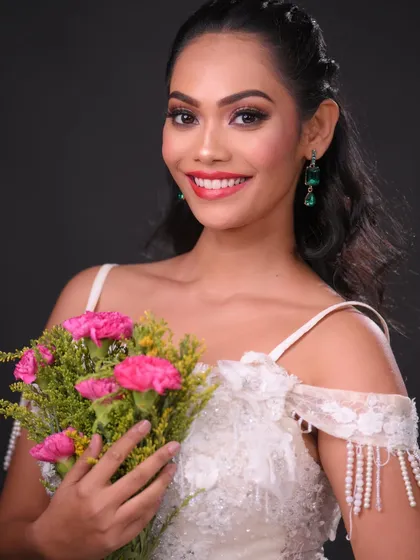 A classic portrait with a bouquet. The red lip provides a beautiful pop of color against the white dress.