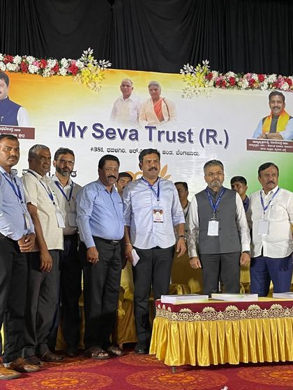 Another group photo on stage, capturing the spirit of service and teamwork.