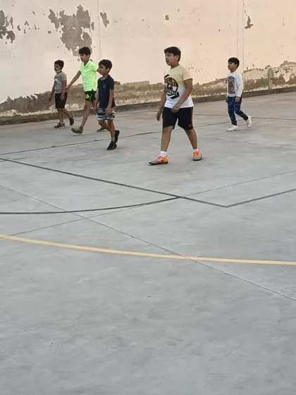 Players walking across the court during a break in training. Even moments of rest are part of a structured coaching session.