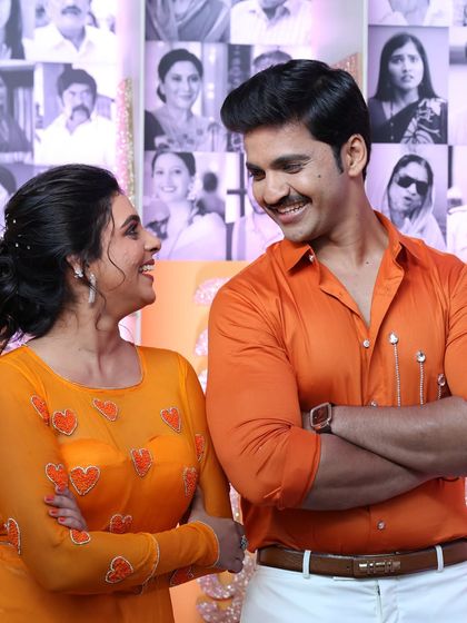 A candid, laughing moment between the two actors. They both look comfortable and radiant in front of the camera.