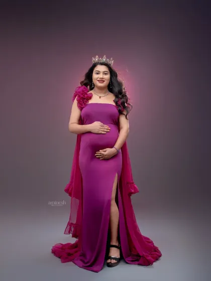 This full-length portrait showcases the elegant silhouette of the magenta gown against a softly lit backdrop. My focus is on creating a balanced and artistic composition.