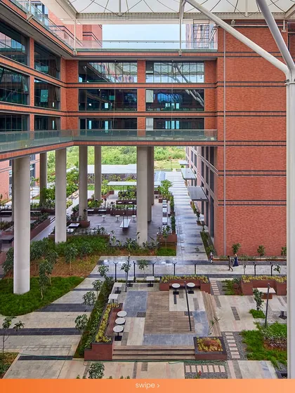 The Wipro Hyderabad Campus features a large central courtyard that serves as a social and circulatory hub. This space is designed to be naturally cooler than the surroundings, with landscaping and shaded areas that encourage employees to connect and collaborate outdoors.