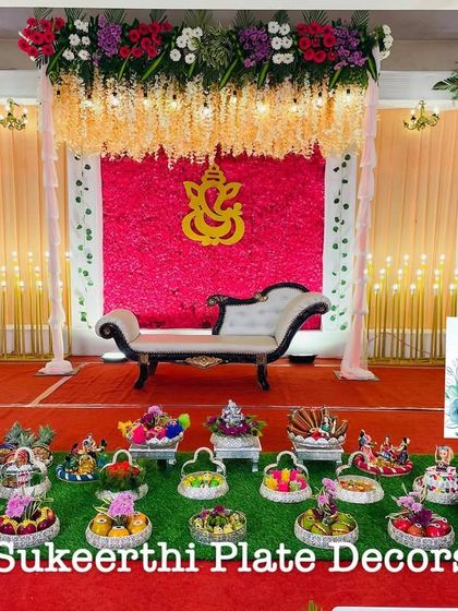 This puberty ceremony setup at Rengaz Mahal features a bright and cheerful stage. My platter arrangements in the front are filled with colorful items to match the festive mood.