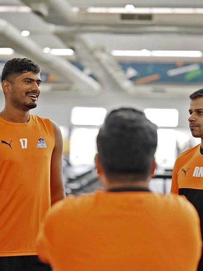 A conversation with one of the players during a gym session. Individual attention and feedback are key to athlete development.