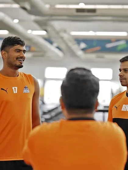 A conversation with one of the players during a gym session. Individual attention and feedback are key to athlete development.