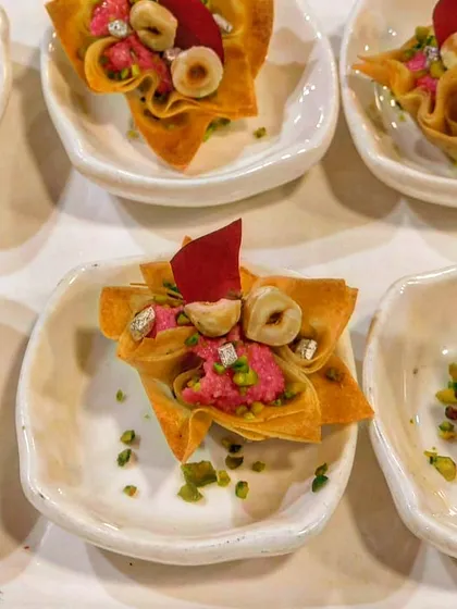 These baked rose and hazelnut filo cups are a testament to my love for detail. Each cup is a crispy, multi-layered bite filled with a fragrant rose cream and topped with crunchy hazelnuts, perfect for a sophisticated dessert table.