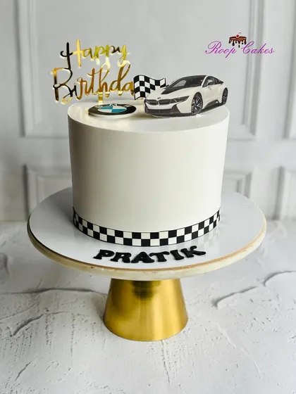 Start your birthday in high gear. A sleek BMW-themed cake for a car enthusiast, complete with a checkered racing stripe and luxury vibes.