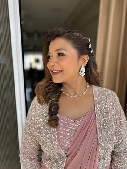 A candid, happy moment. This profile view shows the soft, side-swept hairstyle and the beautiful finish of the makeup.