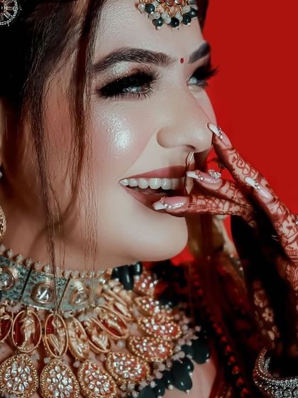 A happy and candid shot of the bride, her smile as bright as her jewellery.