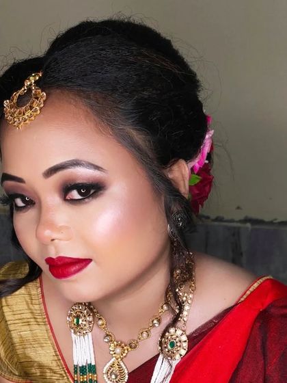 The bride is adorned with flowers in her hair, adding a soft, traditional touch to her look.