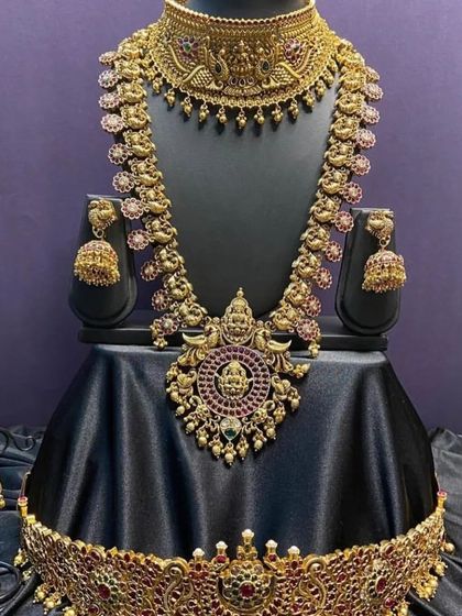 A full bridal set with a unique design, featuring a choker and long necklace with peacock and floral details. The antique finish and kemp stones make it a standout choice for your wedding.