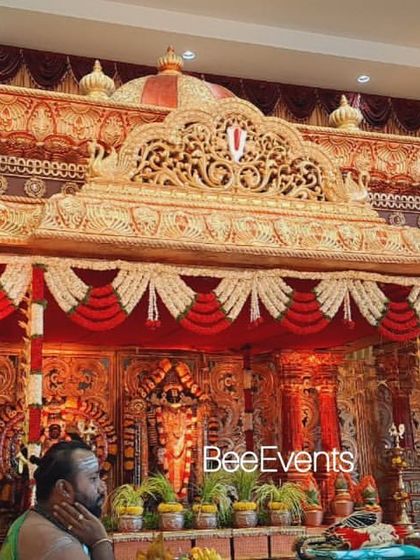 A view of the grand wedding mantap with a priest performing rituals. This image captures the authentic atmosphere of a traditional Hindu wedding ceremony, which we are experts at facilitating.
