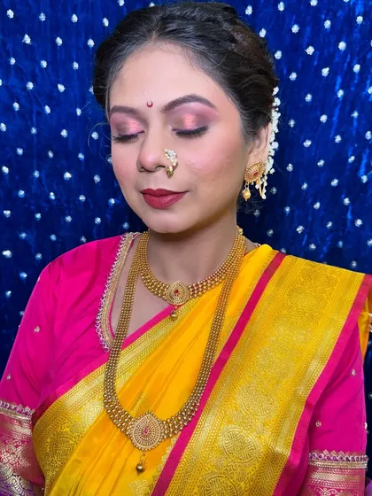 A simple and elegant bridal look with soft pink eyeshadow and a classic red lip. This look is perfect for brides who want a touch of color while keeping it traditional.