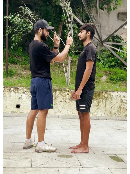 The details are everything. Here, I'm conducting a visual and vestibular assessment, a crucial first step in understanding how an athlete's nervous system influences their movement patterns before we even begin corrective work.