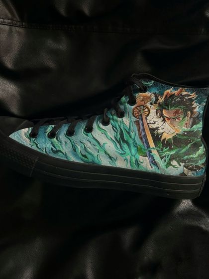 A side profile of the other custom Converse shoe, featuring Tanjiro's water breathing technique.