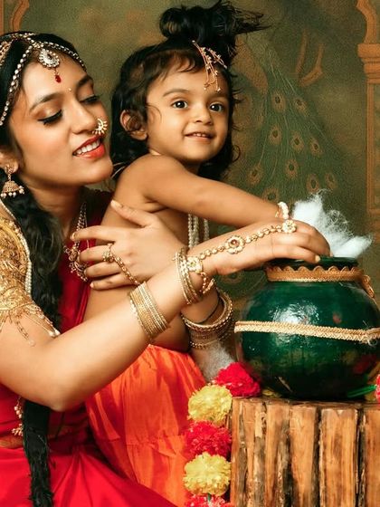 A close-up shot focusing on the little Krishna and the traditional props. Themed shoots are all about creating a complete, immersive scene.