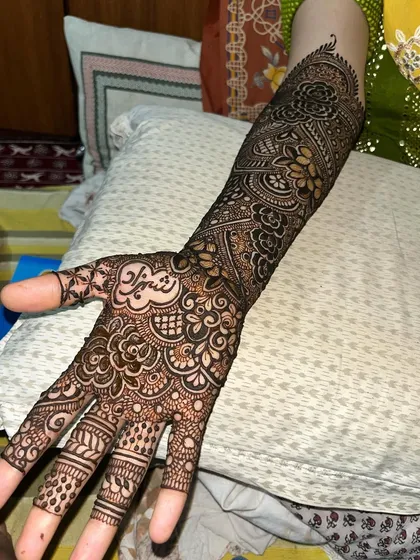 A single-hand view of a bridal design, showing the name 'Afnan' beautifully integrated into the pattern.