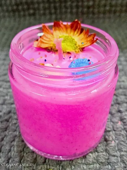 A little sparkle, a little fragrance, and a whole lot of festive love. This bright pink jar candle is topped with a flower for Diwali.