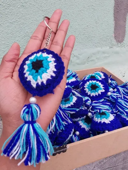 A close-up look at my bestselling evil eye keychain, complete with a handmade tassel. These are popular for personal use and as unique return gifts for parties and events.