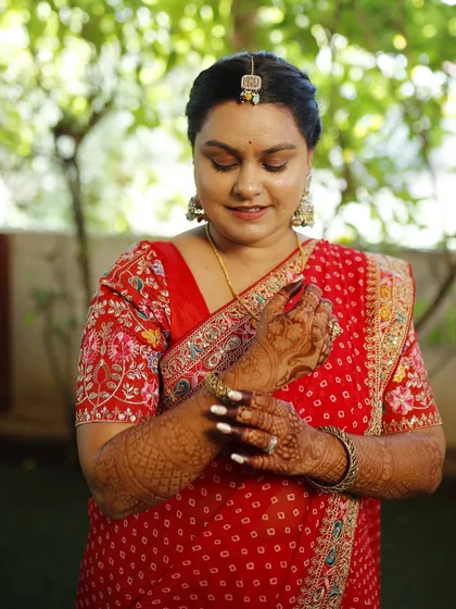 A candid shot of the Haldi bride. Her skin is glowing, and the makeup is minimal to let her natural happiness shine through.