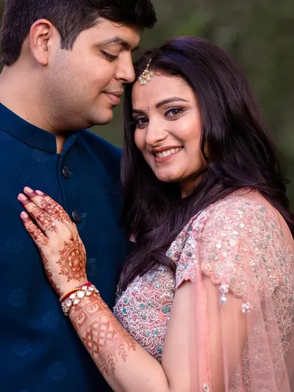 A happy and close portrait of the engaged couple, capturing their genuine smiles.