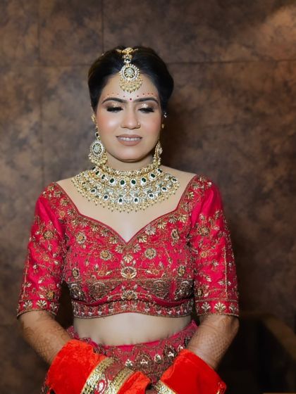 A close-up of this beautiful bride in red. The makeup is traditional yet fresh, with a focus on radiant skin and defined eyes.
