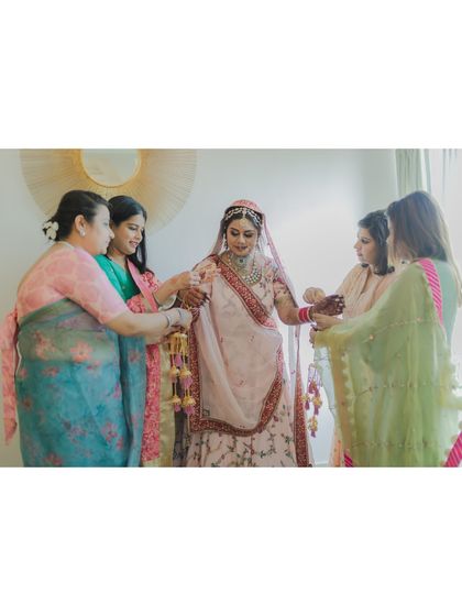 The bride gets help with her 'kalire' from her family members. A beautiful moment of tradition and family bonding.