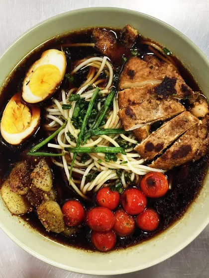 A Labor of Love: Katsu Chicken Shoyu Ramen: Our shoyu ramen broth simmers for 8 hours to develop its deep, umami flavor. We top it with crispy katsu chicken, soft-boiled eggs, and braised cherry tomatoes for a true culinary journey in a bowl.
