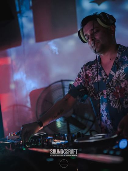 Focused on the mix at the Bootcamp Goa opening party. The projected visuals behind me add to the immersive atmosphere.