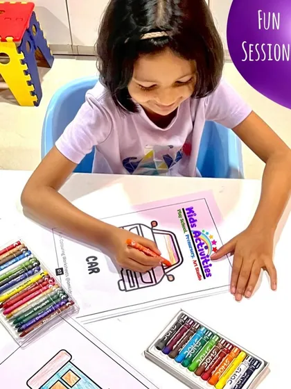 Concentration and joy go hand in hand during our fun coloring sessions. This child is completely absorbed in her activity, carefully choosing crayons to bring her picture to life. These quiet moments are wonderful for developing focus and fine motor control.