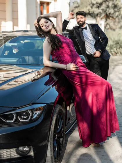 Confidence and style take center stage in this shot featuring a luxury car. The bride's pose is powerful and glamorous, creating a high-fashion image that is both bold and romantic.