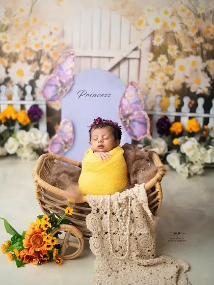 A little princess in her butterfly garden. The combination of soft textures and a floral theme creates a truly magical newborn portrait.