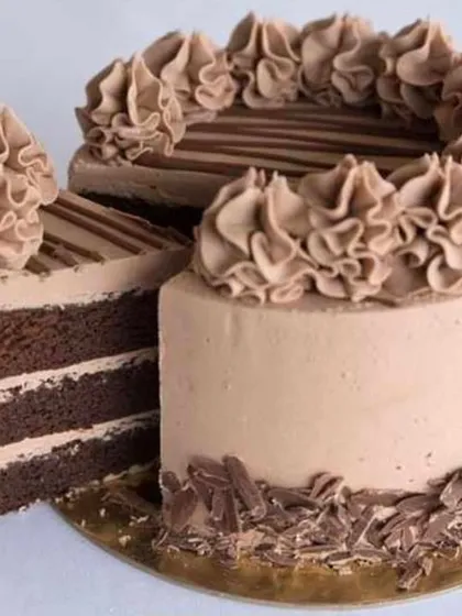 A classic chocolate fantasy cake, showing a perfect slice of its rich, layered interior.