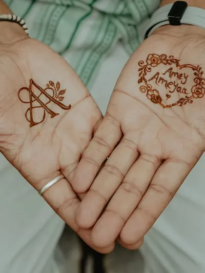 Simple, sweet, and so full of love. On one hand, I created a stylish monogram with the initial 'A', and on the other, I wrote the couple's names, 'Amey & Ameyaa', inside a floral heart.