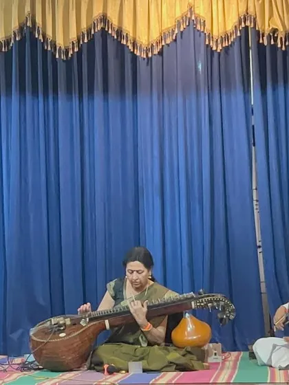 On stage, speaking and performing in memory of Smt. Vimala Rangachar. Music is a powerful way to honor those who have contributed so much to the arts.