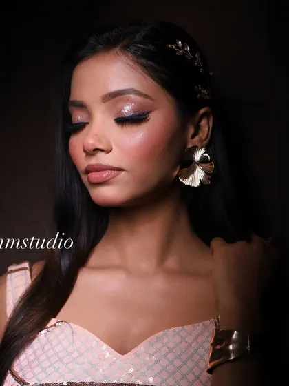 A close-up of the glam look, showcasing the glittery eyeshadow and the flawless skin finish.
