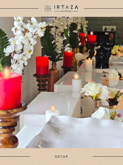A minimalist yet elegant arrangement with white risers, red candles, and simple floral accents, proving that luxury doesn't always have to be ornate.