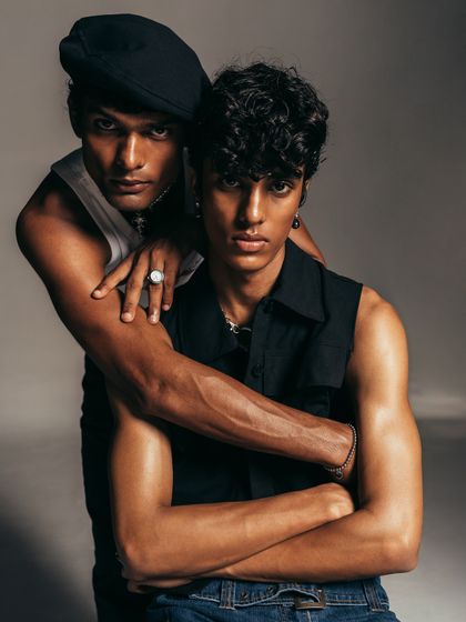 Another angle from the same series, this pose emphasizes a protective and strong dynamic. The styling remains consistent, allowing the models' interaction to be the primary focus of the narrative.