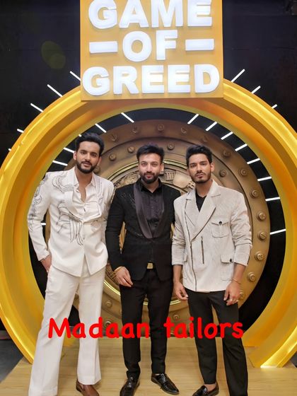 The full coordinated look for the hosts of 'Game of Greed'. Our designs included a white embroidered suit, a textured black tuxedo, and a modern off-white jacket, creating a powerful and stylish trio.