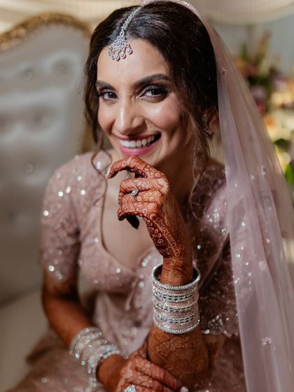 A happy and confident bride, smiling brightly for the camera. Her joy is the most beautiful accessory.