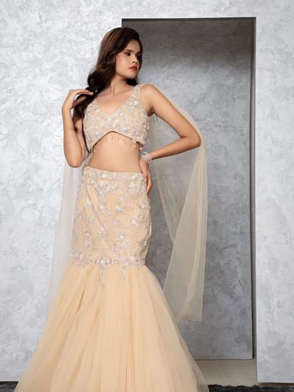 Another angle of the beige mermaid gown, showing off its elegant fit and the subtle shimmer of the embellishments. A truly glamorous rental option.