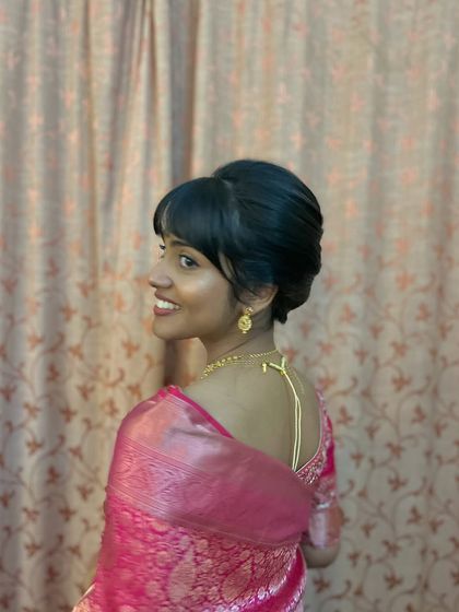 A chic updo with a modern fringe, or bangs, for a youthful and stylish look.