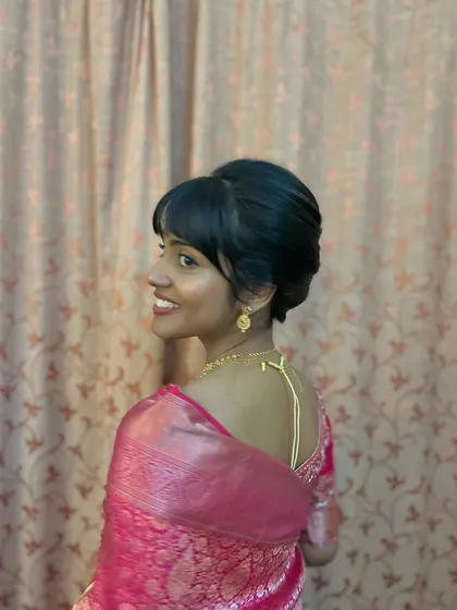 A chic updo with a stylish fringe. This is a great option for clients who want a modern and fashionable look.
