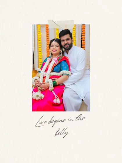 A sweet, framed portrait of the couple from their baby shower, with the caption 'Love begins in the belly'.