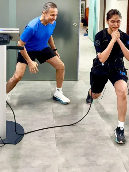 A client performs a lunge during a one on one session, with the EMS suit amplifying every muscle contraction. This deep muscle activation is key for boosting metabolism and building lean muscle, making it a powerful tool for weight loss and body toning.