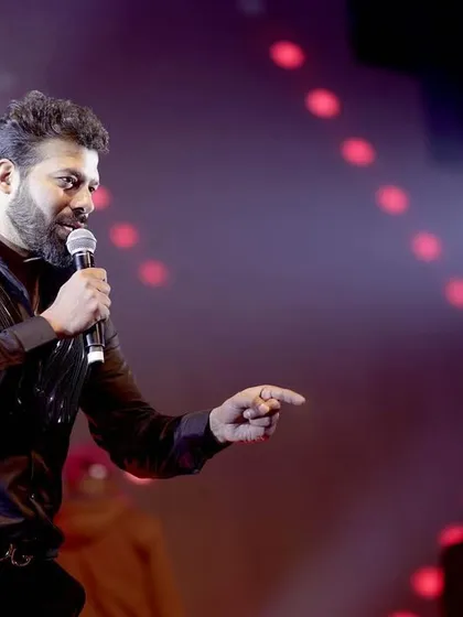 A shot of the live band singer engaging with the crowd, capturing the energy of the performance.