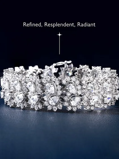 Refined, resplendent, radiant. This magnificent diamond bracelet is designed for maximum sparkle, with intricate clusters of pear-shaped and round diamonds. It is a true statement of elegance and luxury.